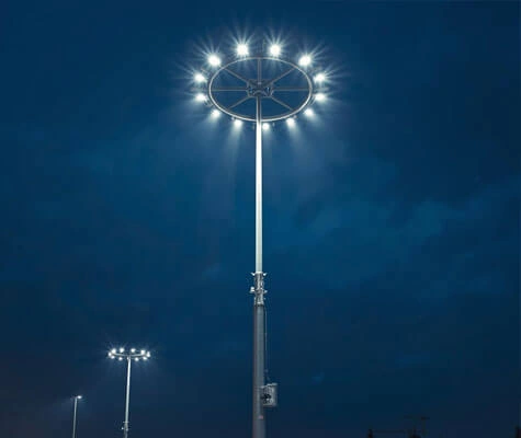 Electric winch mechanism lowering luminaire ring in motorised high mast pole